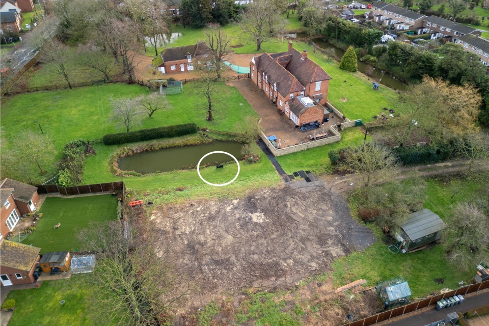 Aerial photos show the black steel bench in the empty grounds of the property