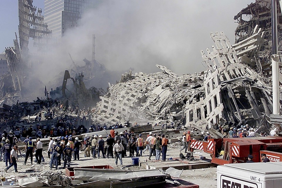 Fire and rescue workers search through the rubble of the Twin Tower attacks on 9/11