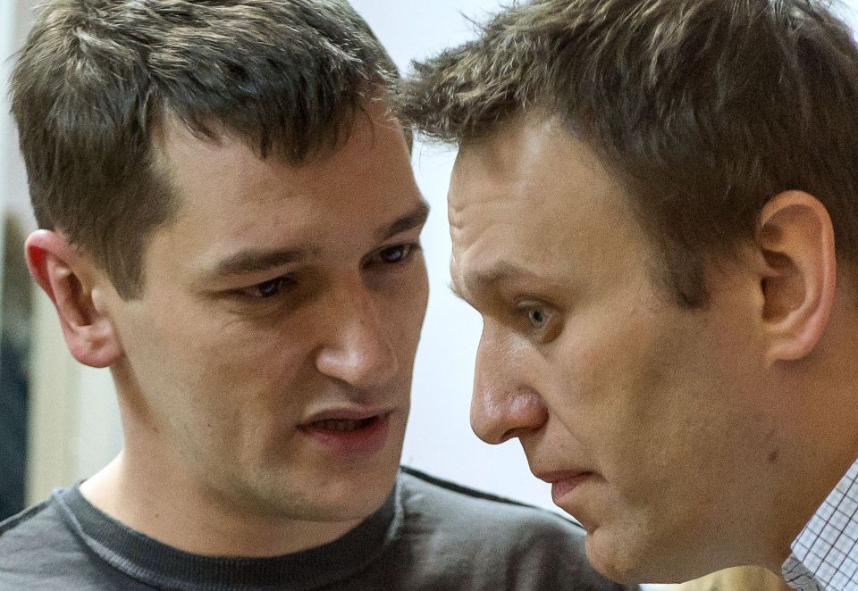 Alexei Navalny, right, and Oleg speak during the verdict announcement of their fraud trial in 2014