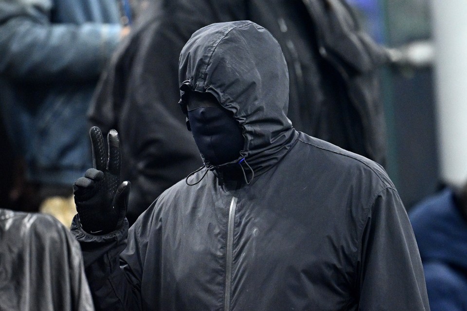 The rapper wore all black - including a mask over his entire face