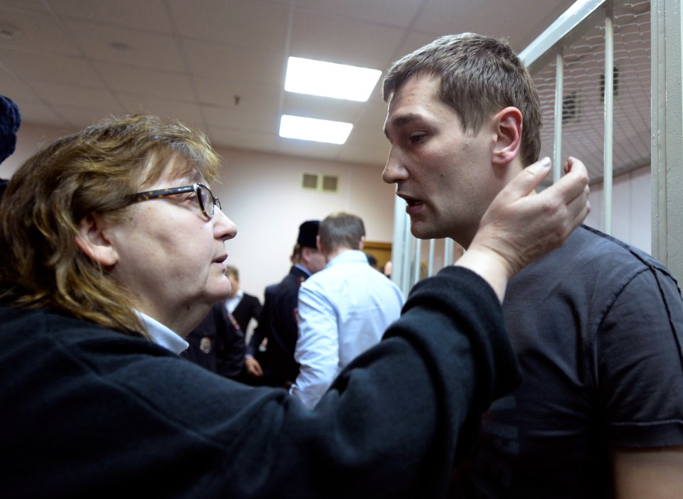 Oleg Navalny speaks with his mother Lyudmila, left, at a court in Moscow, Russia