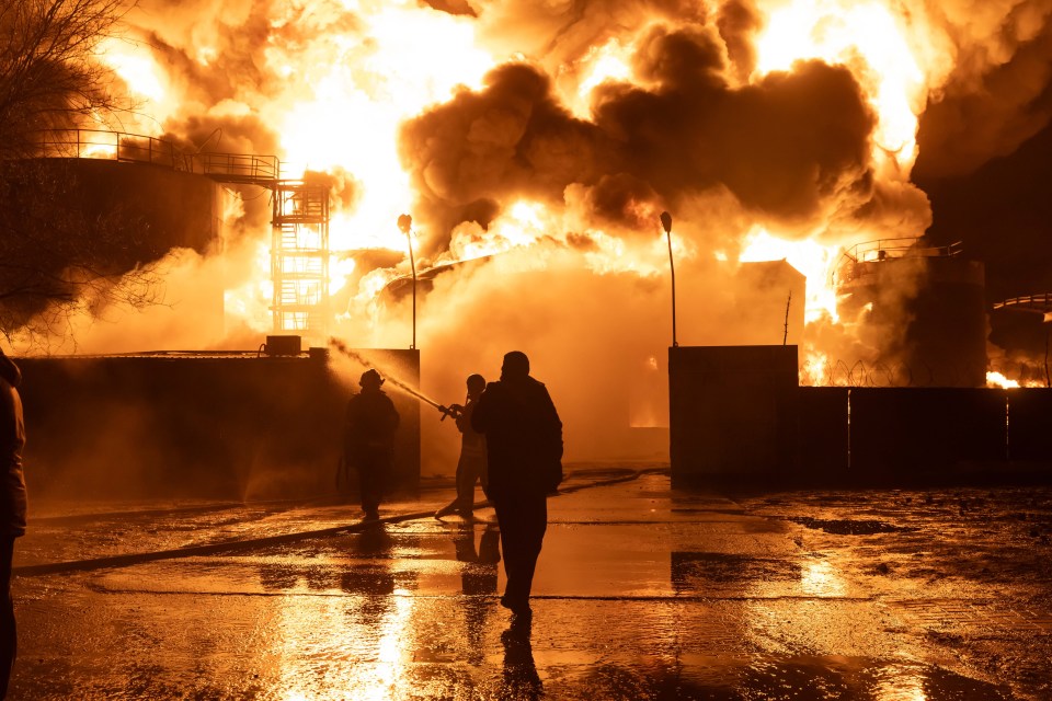 Firefighters try to extinguish the flames after a gas station was struck by Russian drones in Kharkiv, Ukraine