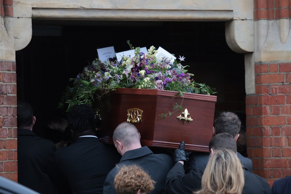 Derek's coffin, covered in flowers, greenery, and love notes from family, enters the church this morning