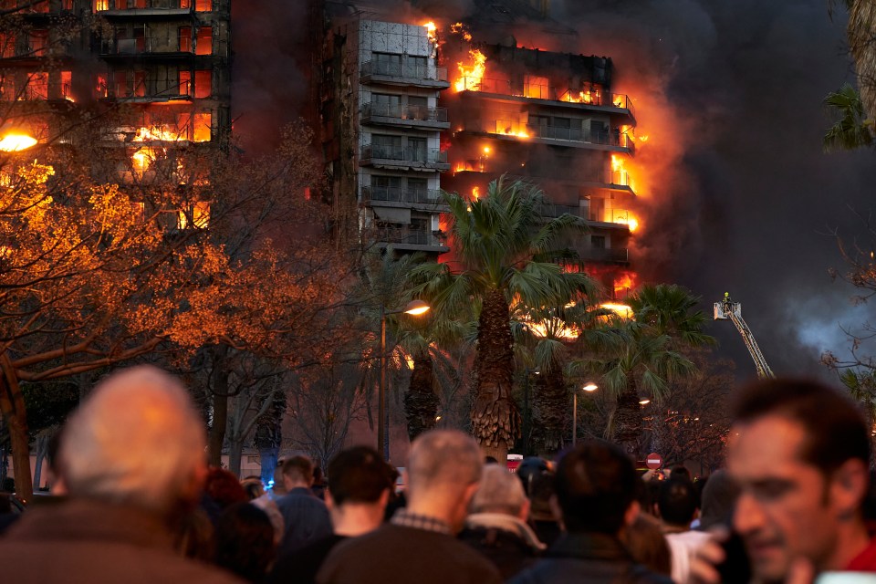 Crowds of people stood watching the fire spreading