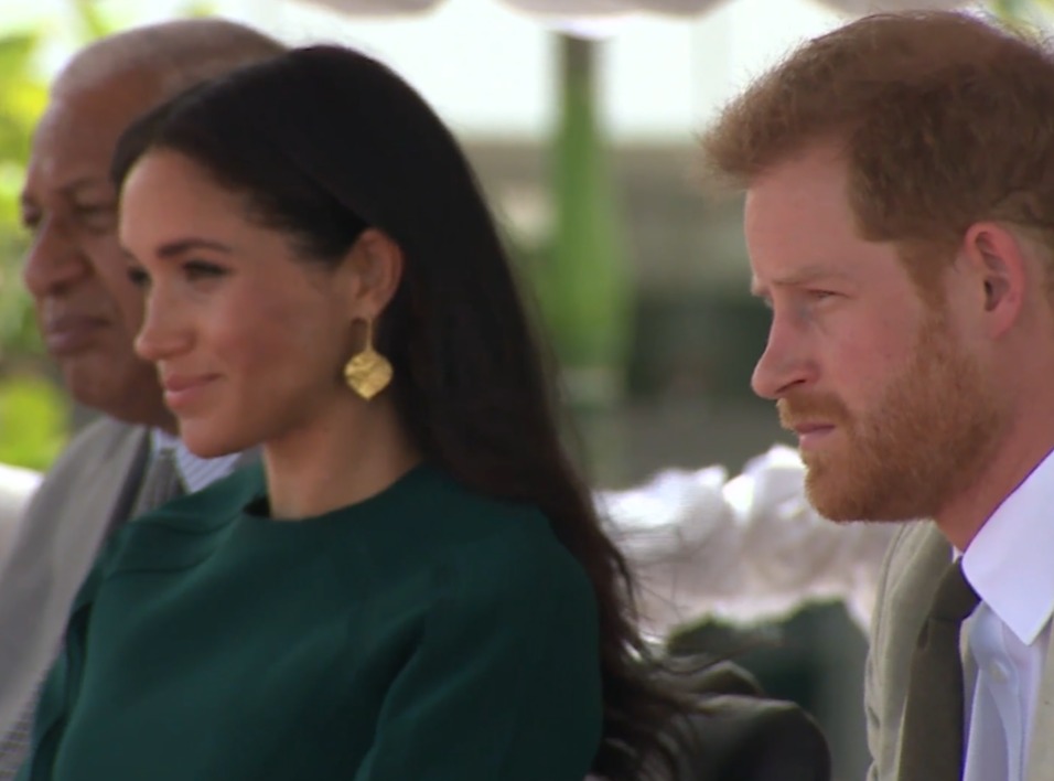 Meghan put on a Hollywood smile while Prince Harry grimaced through a ceremony in Fiji