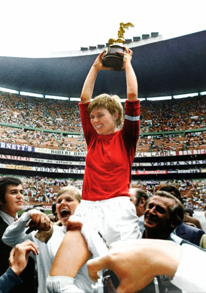 Denmark's Inger Pedersen lifts the trophy in an echo of England's Bobby Moore in 1966