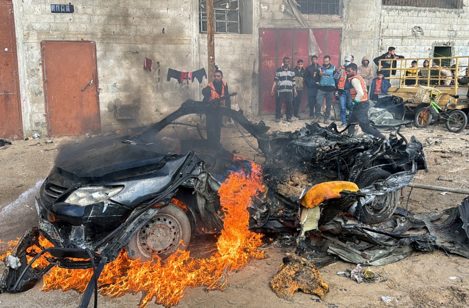 Firefighters in Gaza extinguished the flaming shells of cars hit in this morning's airstrikes