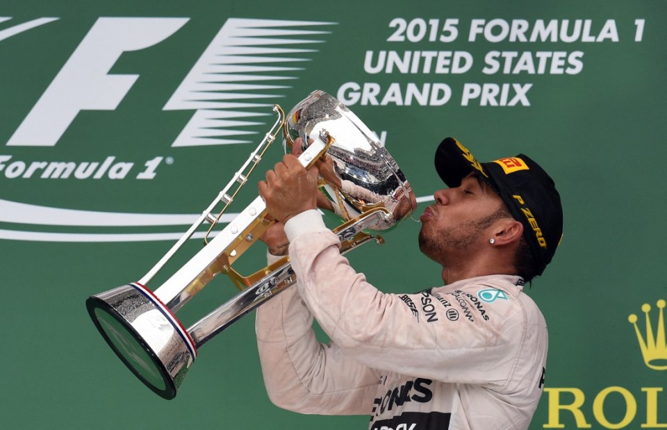 (FILES) Mercedes AMG Petronas British driver Lewis Hamilton drinks champagne from his trophy on the podium after winning the US Formula One Grand Prix at the Circuit of The Americas in Austin, Texas, on October 25, 2015. Seven-time Formula One world champion Lewis Hamilton will leave Mercedes at the end of the 2024 season, the team announced February 1, 2024, ahead of an expected move to Ferrari for 2025 season. "Lewis has activated a release option in the contract announced last August and this season will therefore be his last driving for the Silver Arrows," Mercedes said in a statement. (Photo by JEWEL SAMAD / AFP) (Photo by JEWEL SAMAD/AFP via Getty Images)