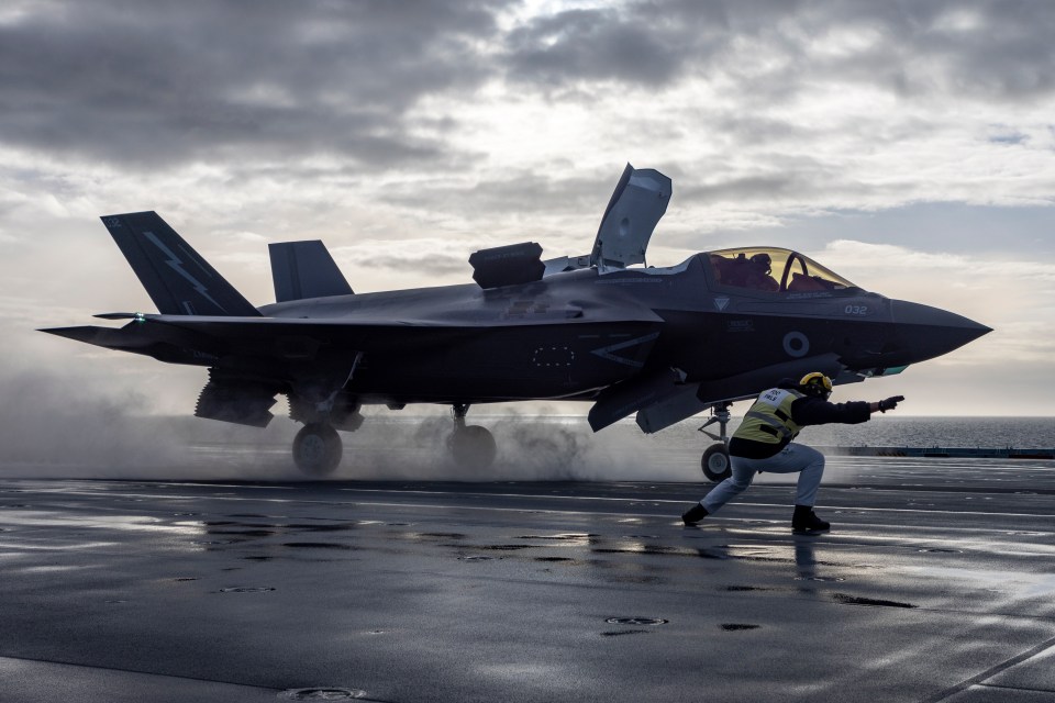 One of the powerful jets landing on the aircraft carrier