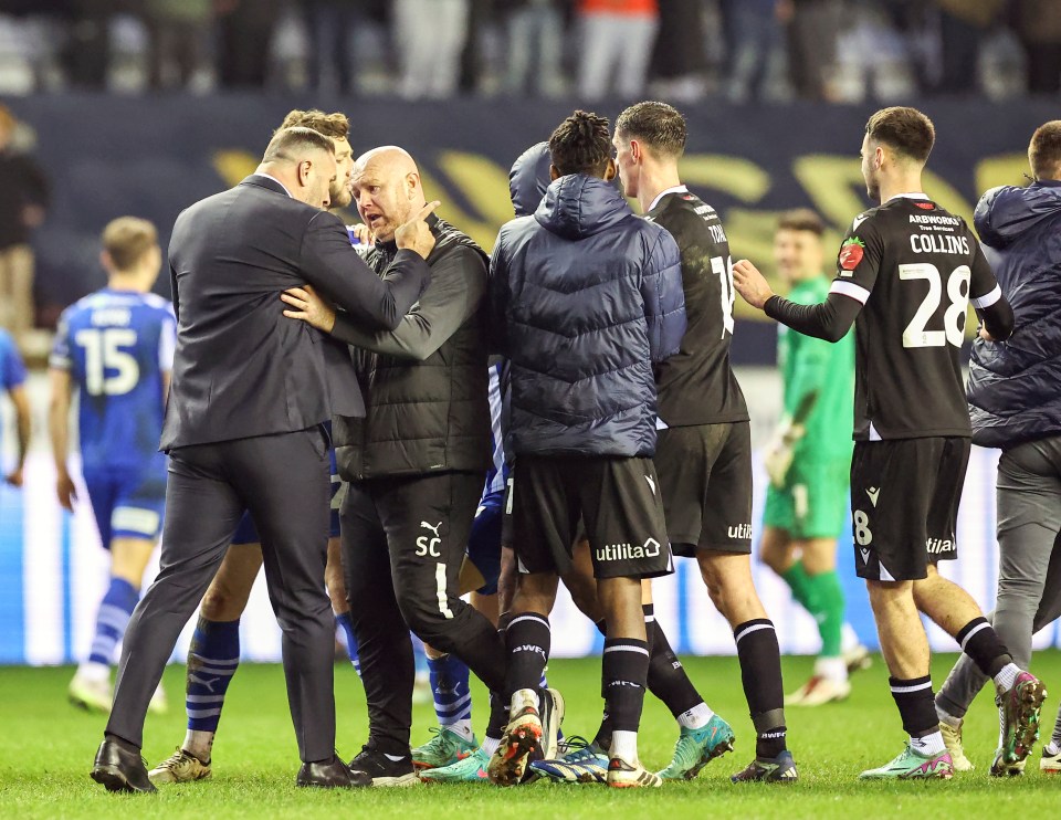 Bolton boss Ian Evatt was spotted rowing with Wigan staff during the melee