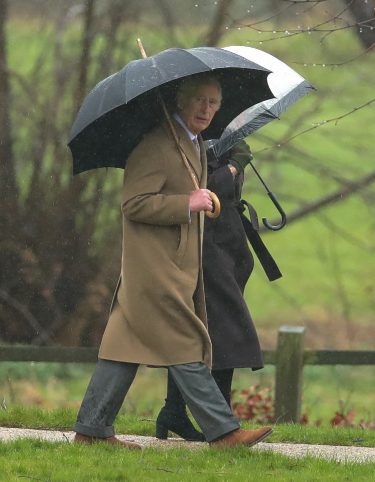 The pair battled the elements as they walked to a service at St Mary Magdalene on the royal estate in Norfolk.