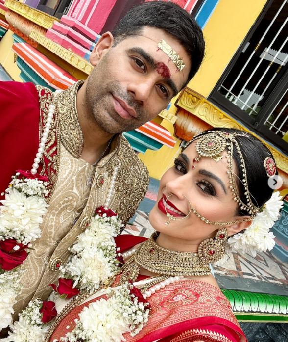 She could be seen beaming as she posed for snaps in her traditional wedding attire with her husband Darren Kuppan