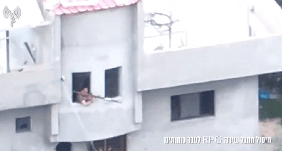 Footage shows a Hamas militant aiming an RPG out of a window