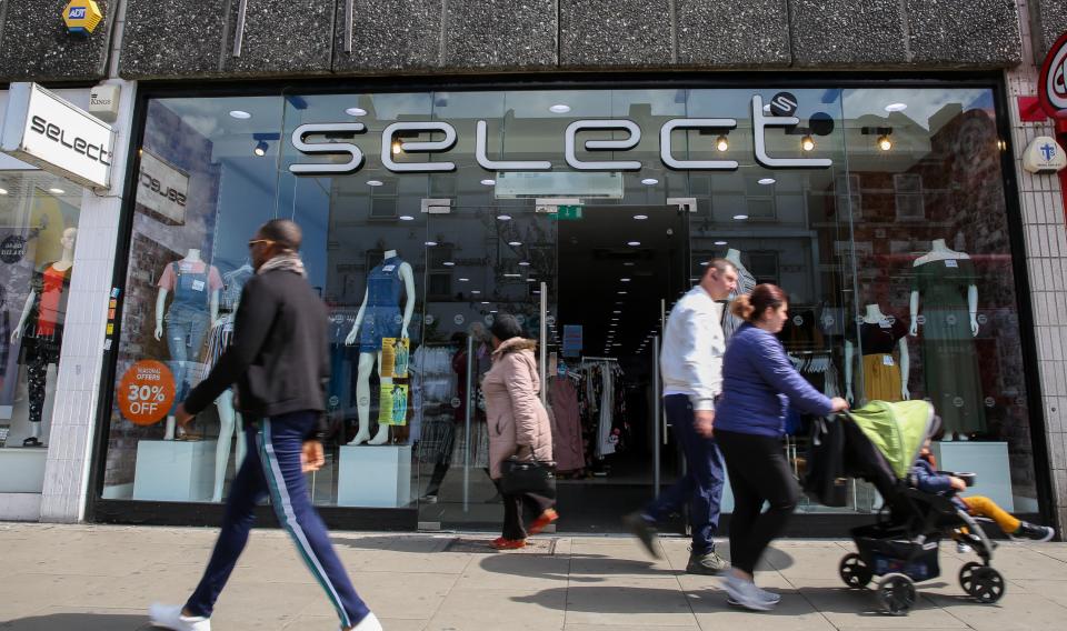 Shoppers walking past a Select fashion store in London.