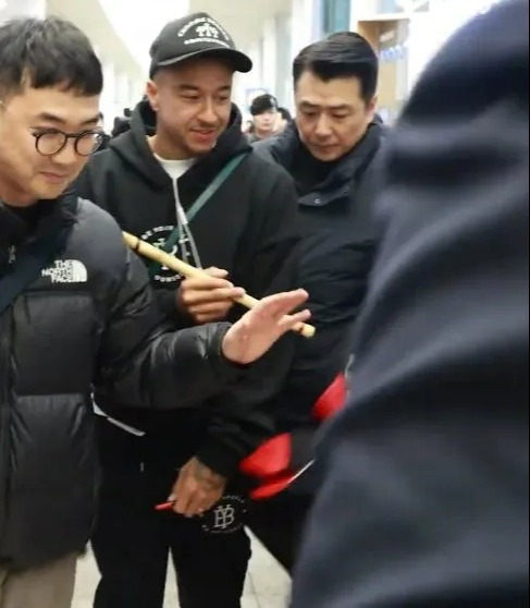 He was handed a flute after touching down to complete his FC Seoul transfer