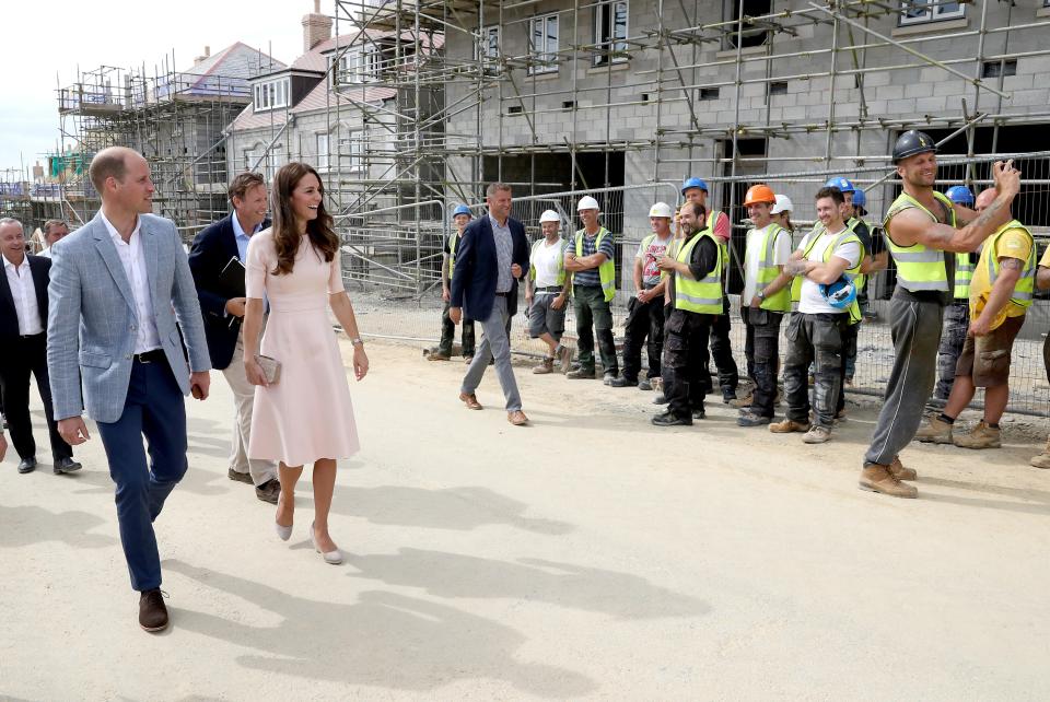 The Duke and Duchess of Cambridge share a joke with construction workers in Nansledan