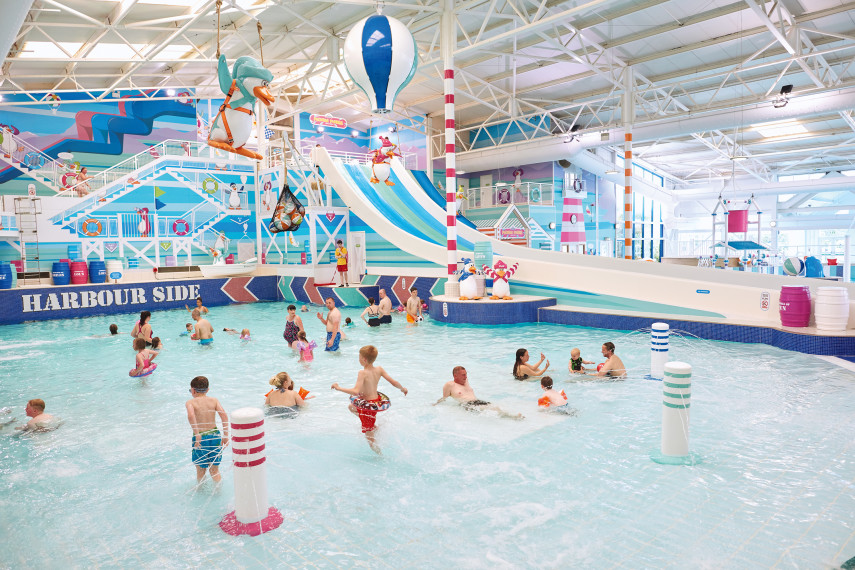 The indoor pool area at Hafan Y Môr features a lazy river, a multi-lane waterslide, tipping buckets and separate swimming lanes