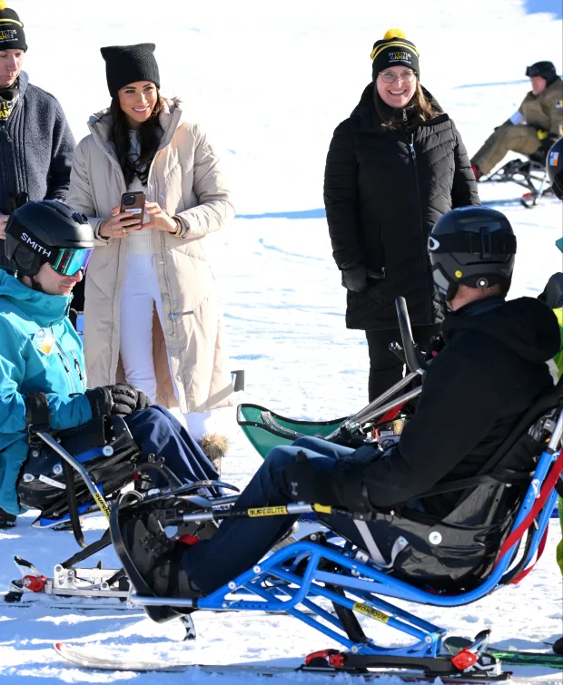 Meghan watching Harry try out sledding in Canada