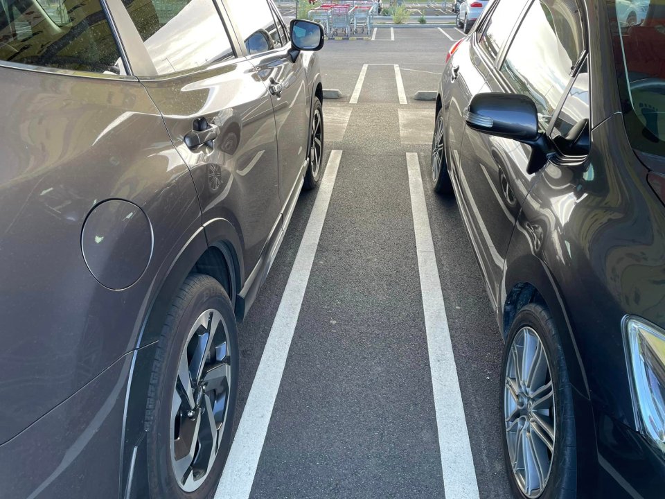 The double lines create extra space between two cars