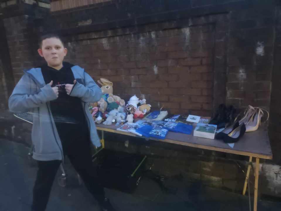 Joshua, 11, pictured with all the goodies on his stall outdoors