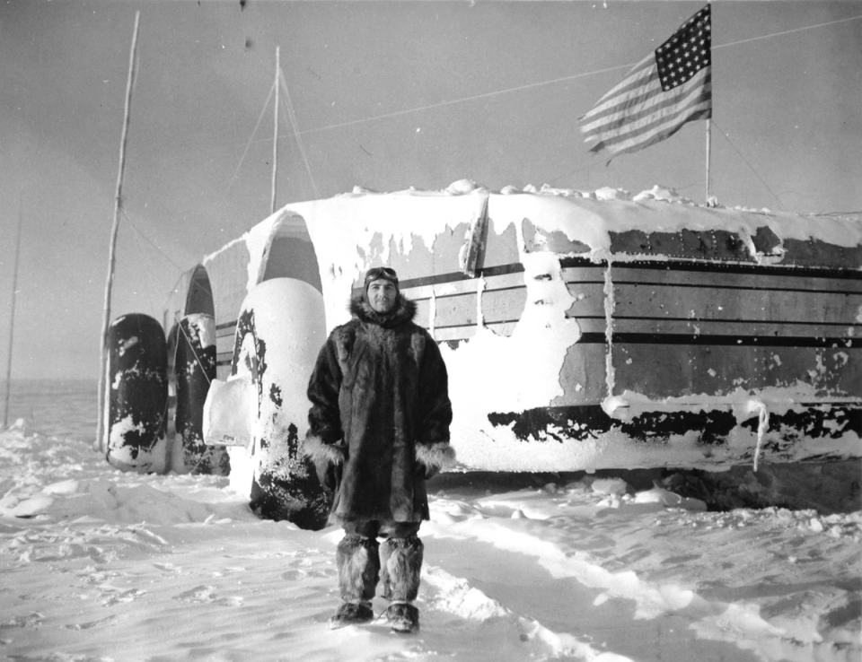 Crew member T.A. Petras stands behind the Snow Cruiser on September 20, 1940