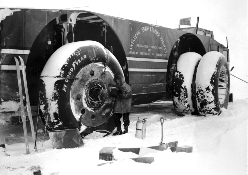 Sergeant Felix Ferranto, radio operator, works with a primus torch to thaw out the wheel motors of the Snow Cruiser on August 23, 1940