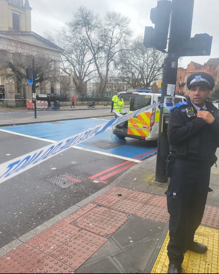 A police officer guards a cordon at the scene earlier today