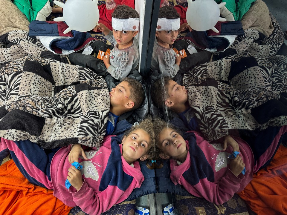 Palestinian children wounded in an Israeli strike rest as they receive treatment at a hospital in Rafah