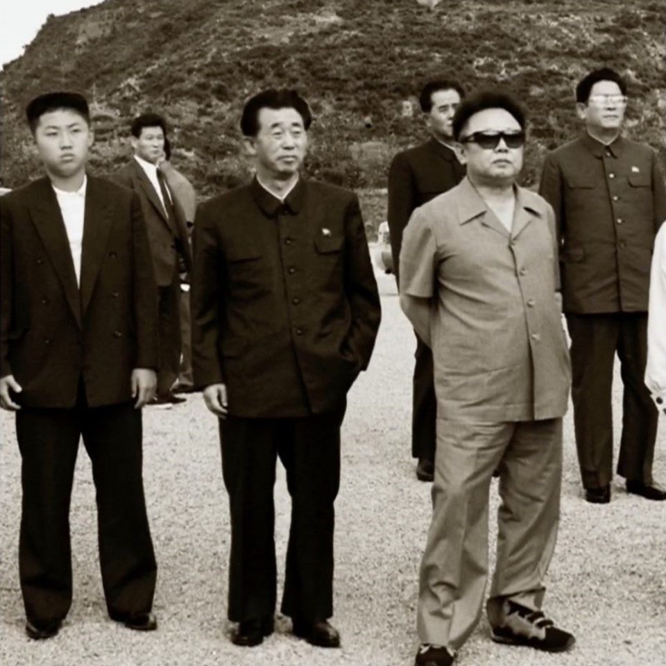 The young tyrant pictured left alongside his father and predecessor, Kim Jong-il, who wears sunglasses