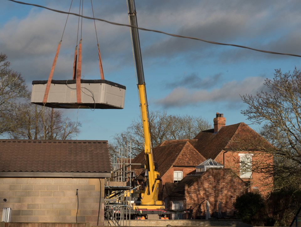 A crane lifted the £25k spa out of the building and onto a waiting lorry