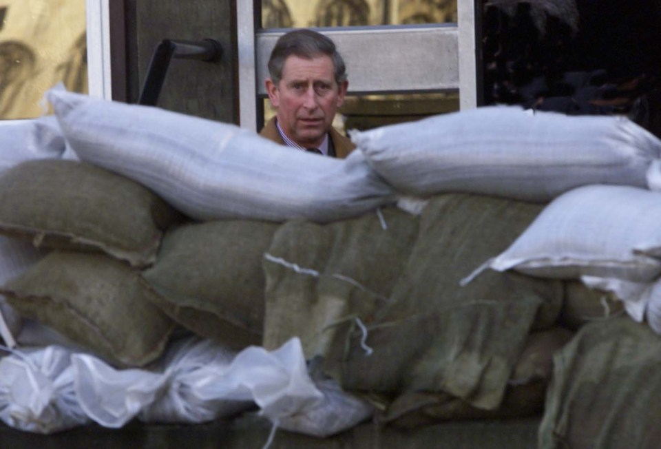 The then prince looks at sandbags for floods on 2000 York visit