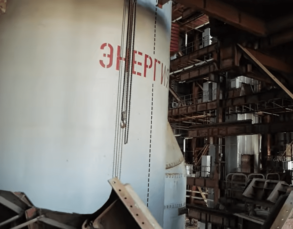 Rusty chains dangling around the rocket give away how long the rocket has been abandoned for