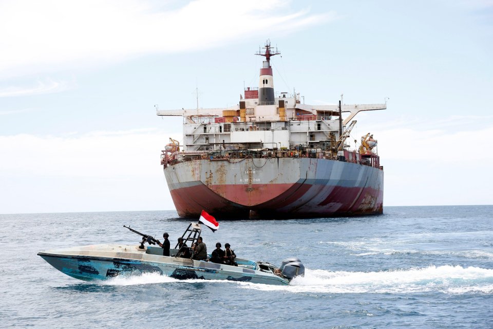 A Yemen’s coast guard boat sails past the FSO Safer vessel at Ras Issa port in Hodeidah province, Yemen, in May 2023