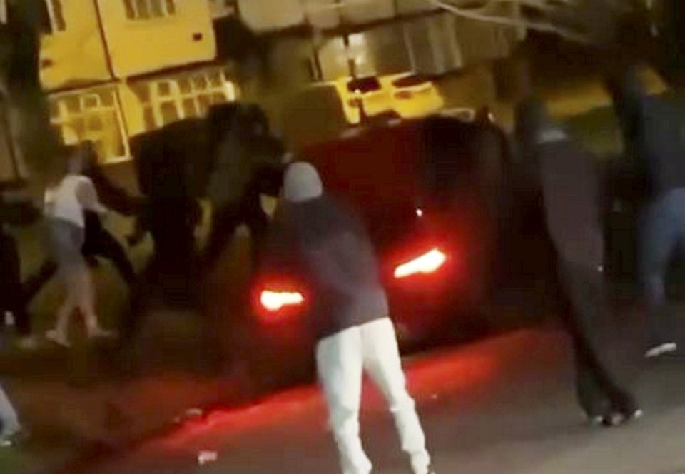 The video clip recorded shows people kicking and punching the car