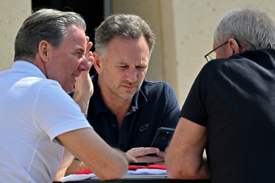 Horner (C) looking a bit nervous as he sat with team advisor Helmut Marko (L) during the pre-season testing at the Bahrain International Circuit