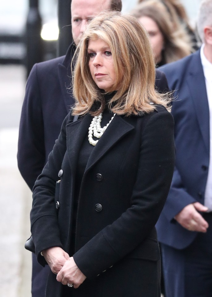 Kate watches on as Derek's coffin was removed from the hearse