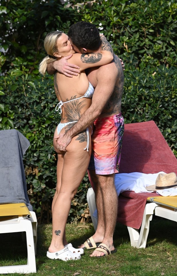 Kerry Katona’s fiancé grabbed her tattooed bum as they snogged on holiday