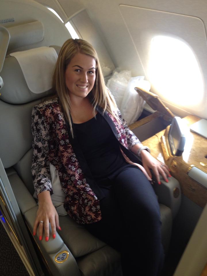 Carly Taylor posing in a first-class seat while jetting off on a luxury holiday