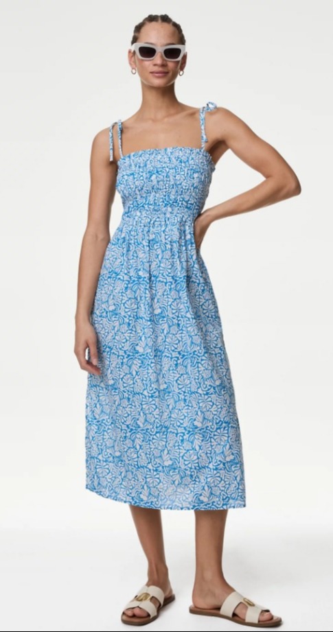 Fashion fans have been going wild for the  'Pure Cotton Floral Shirred Midi Beach Dress' from M&S