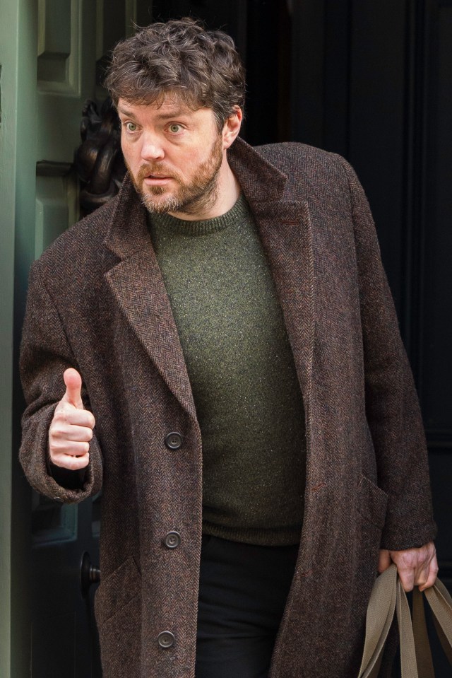 Tom Burke gives the thumbs up during filming for new episodes of Strike