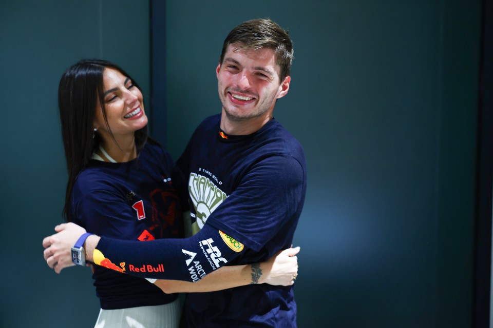 a man and a woman are hugging and the man is wearing a shirt that says red bull