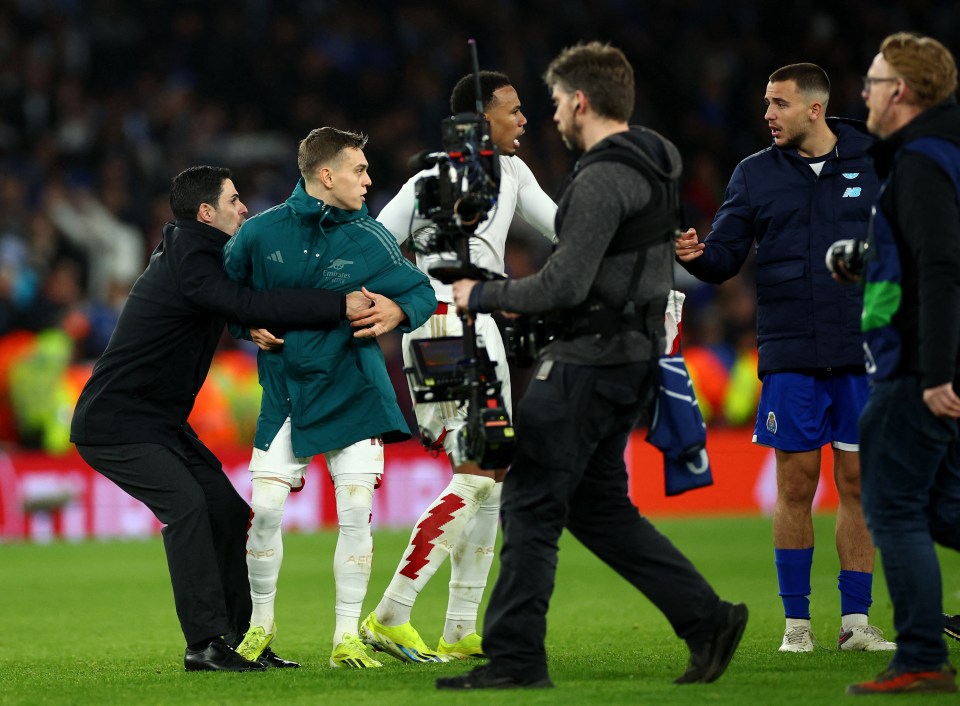 Arsenal boss Mikel Arteta gets to grips with his own player Leandro Trossard in an attempt to calm post-match confrontations