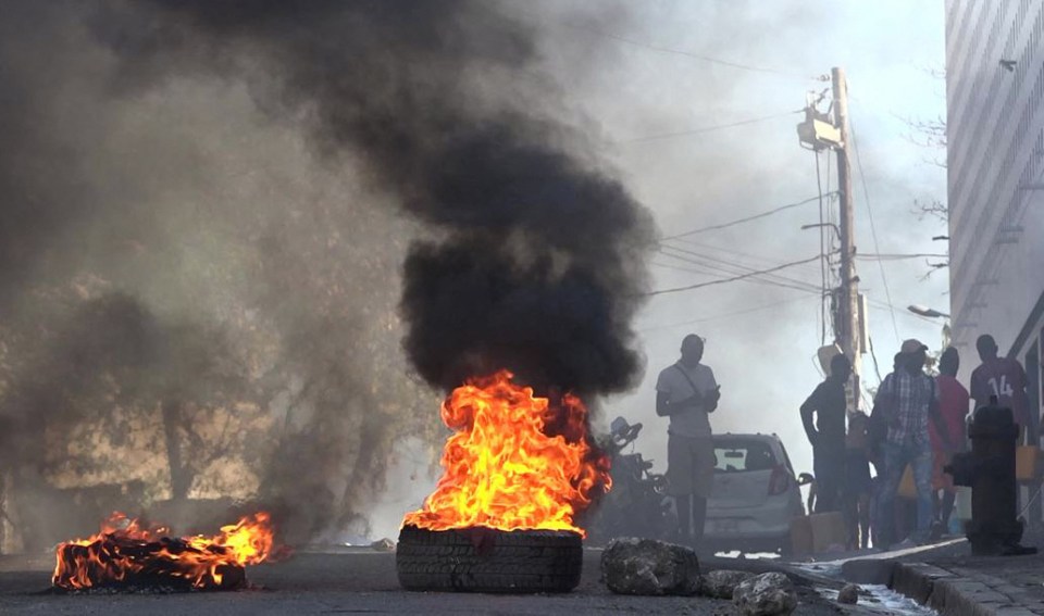 The smouldering wreckage of buses, tyres and bodies line the streets