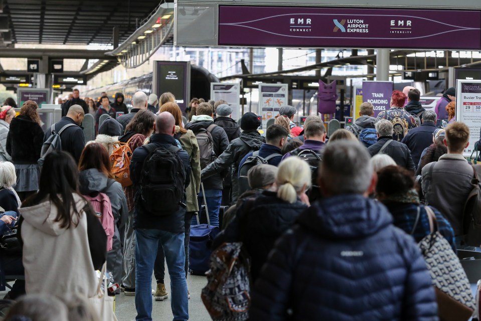 Passengers queue at King's Cross St Pancras in central London