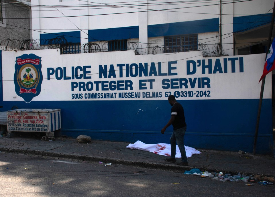 A body lies outside a police centre after a shootout