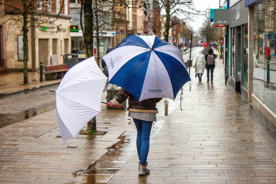 This shopper in Preston, Lancashire, wasn’t taking any chances earlier in the week with two umbrellas