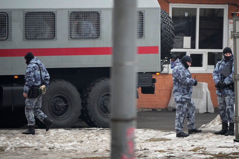 Riot police officers guard the area near the church