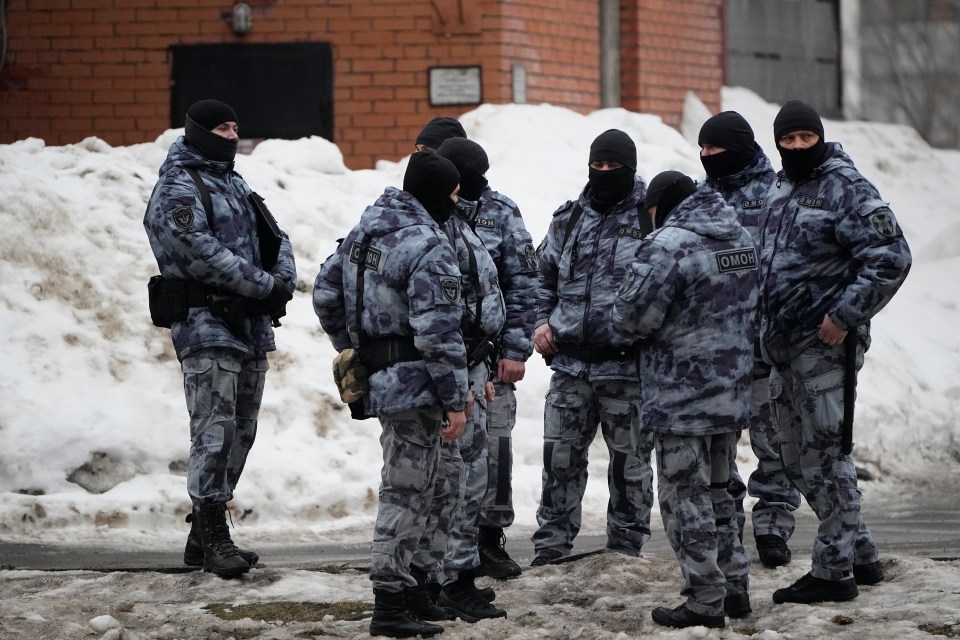 Riot cops patrol the area on the ground