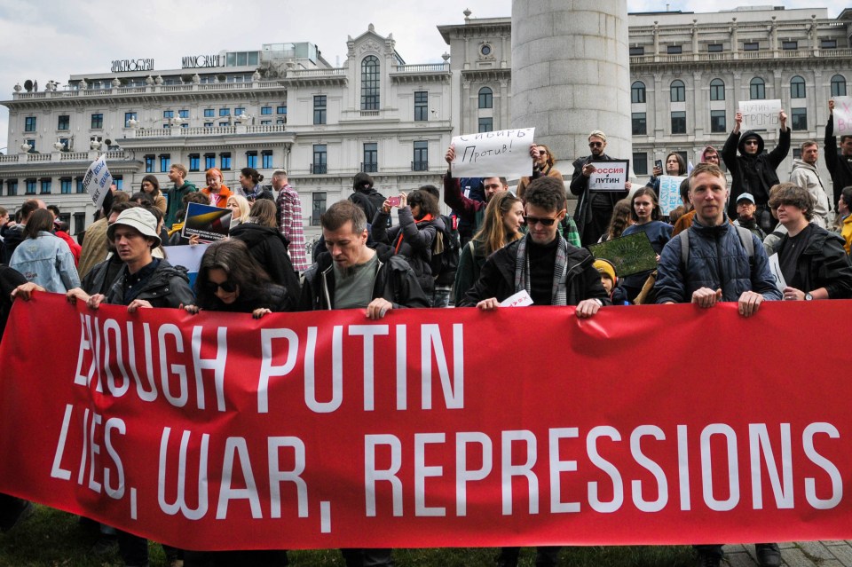 People protest in Georgia at noon today with angry signs