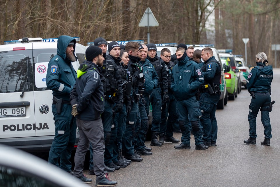 Police officers patrolling the area near the house of Leonid Volkov